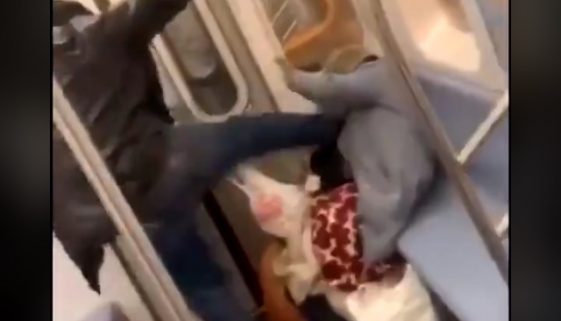man kicks woman on train